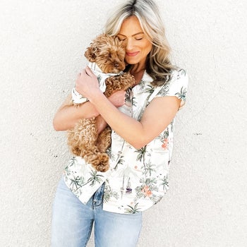 Model holding puppy with matching white palm tree shirts