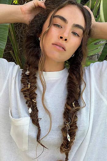 Another model wearing them in two braids