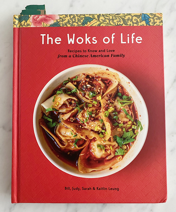 the red Woks Of Life cookbook cover featuring a bowl filled with dumplings