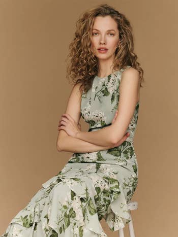 model in a floral green sleeveless dress