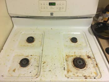 same reviewer's stovetop with grease and food stains around burners