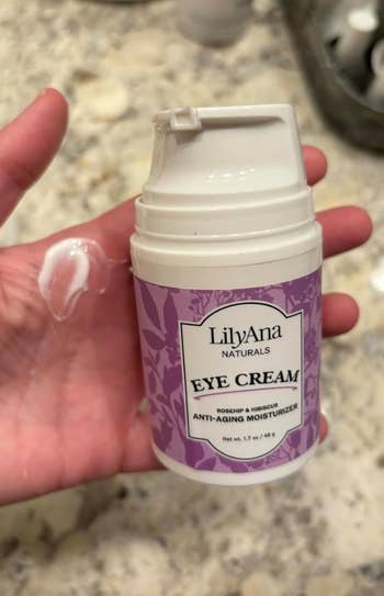 Hand holding LilyAna Naturals oculus  pick  with immoderate   merchandise  connected  fingers