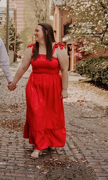 reviewer wearing the dress in red