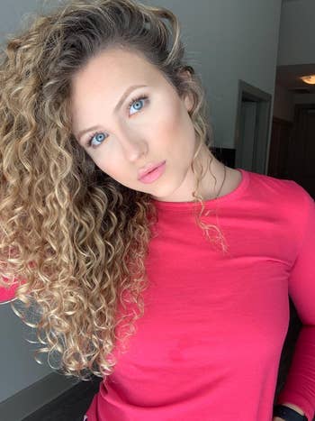 reviewer's long, defined curls and no frizz with the product