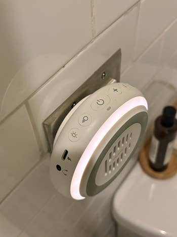 Night airy and aerial purifier plugged into a bath outlet, featuring power, light, and instrumentality controls