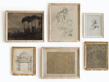 Assorted framed artworks on a wall, including landscapes and sketches, ideal for home decor enthusiasts