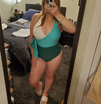 reviewer wearing cross front one piece bathing suit in blue color