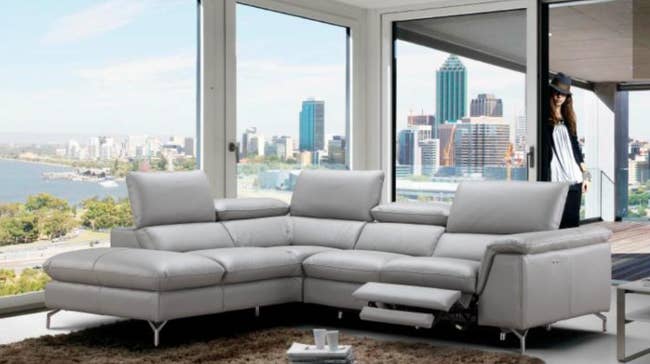 lifestyle photo of light gray leather reclining sectional couch