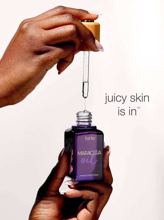 Hands holding Tarte maracuja lipid  vessel  and dropper; substance   reads 