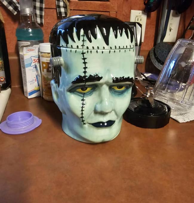 Cookie jar designed to resemble Frankenstein's monster, placed on a kitchen counter