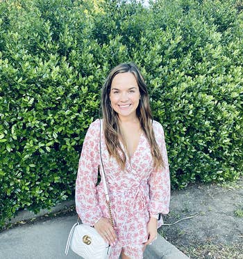 reviewer in same romper with a pink floral pattern