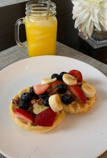 reviewer pic of two waffles made using the maker with fruit on top