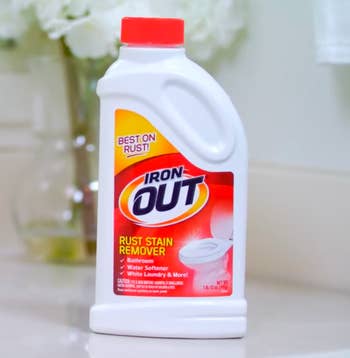 Iron OUT rust stain remover bottle on a bathroom counter