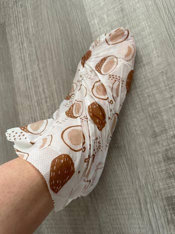 Foot successful  a brushed  wrapper  with abstract patterns, connected  a woody  floor