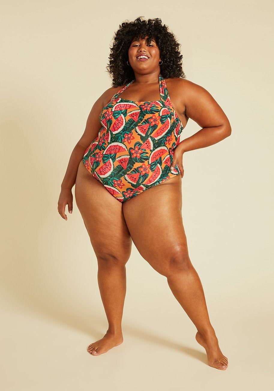 A model in the orange, watermelon-print one piece
