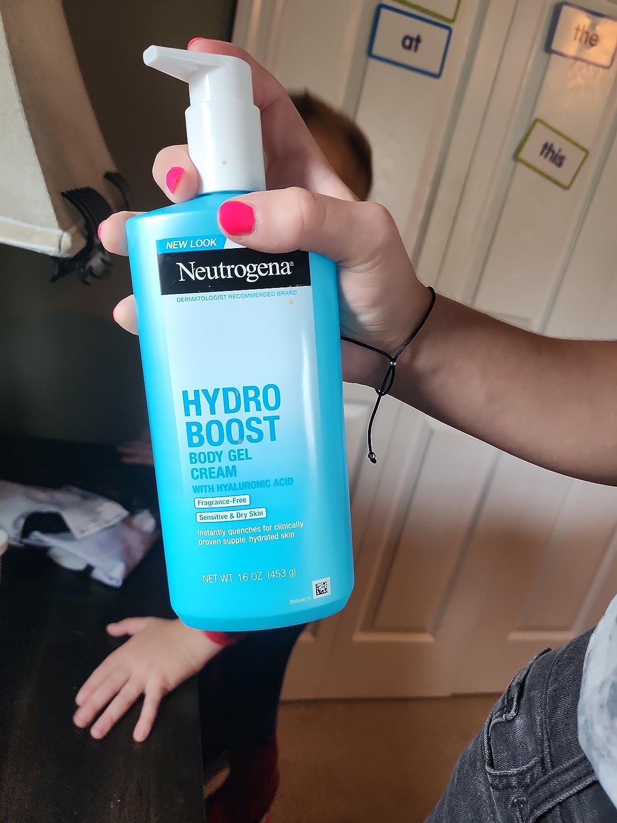Person holding a vessel  of Neutrogena Hydro Boost Hydrating Body Gel Cream with hyaluronic acid, successful  a location  setting