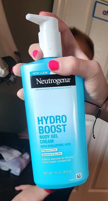 Person holding a vessel of Neutrogena Hydro Boost Hydrating Body Gel Cream with hyaluronic acid, successful a location setting