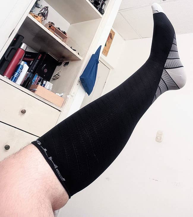 reviewer wearing the compression sock