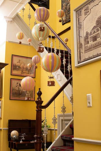 A staircase with a wide assortment of the hot air balloon models