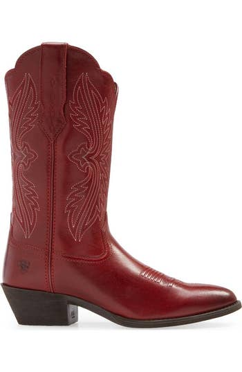 Red cowboy footwear  with elaborate  stitching and a debased  heel