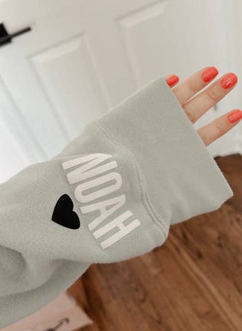 a sweatshirt sleeve in mint that says 