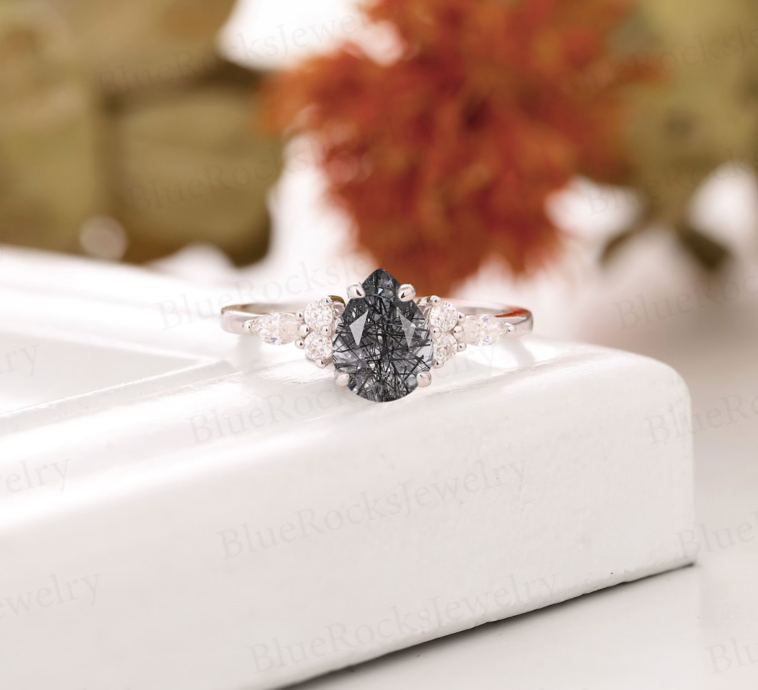 The black quartz ring in a pear shape with diamonds slightly down the silver band
