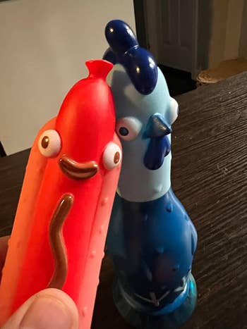 A red hotdog and a blue chicken game piece
