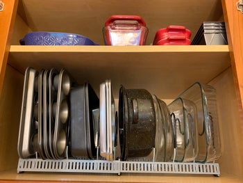 reviewer image of bakeware in the expandable organizing rack