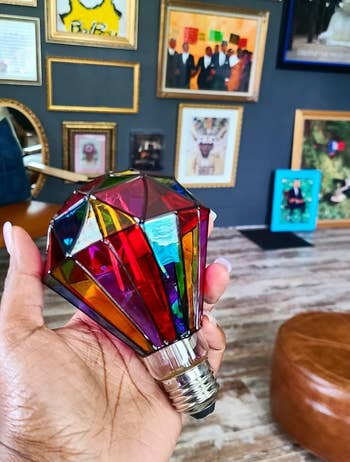 a reviewer holding the diamond-shaped bulb