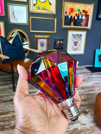 a reviewer holding the diamond-shaped bulb