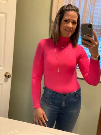reviewer wearing pink bodysuit