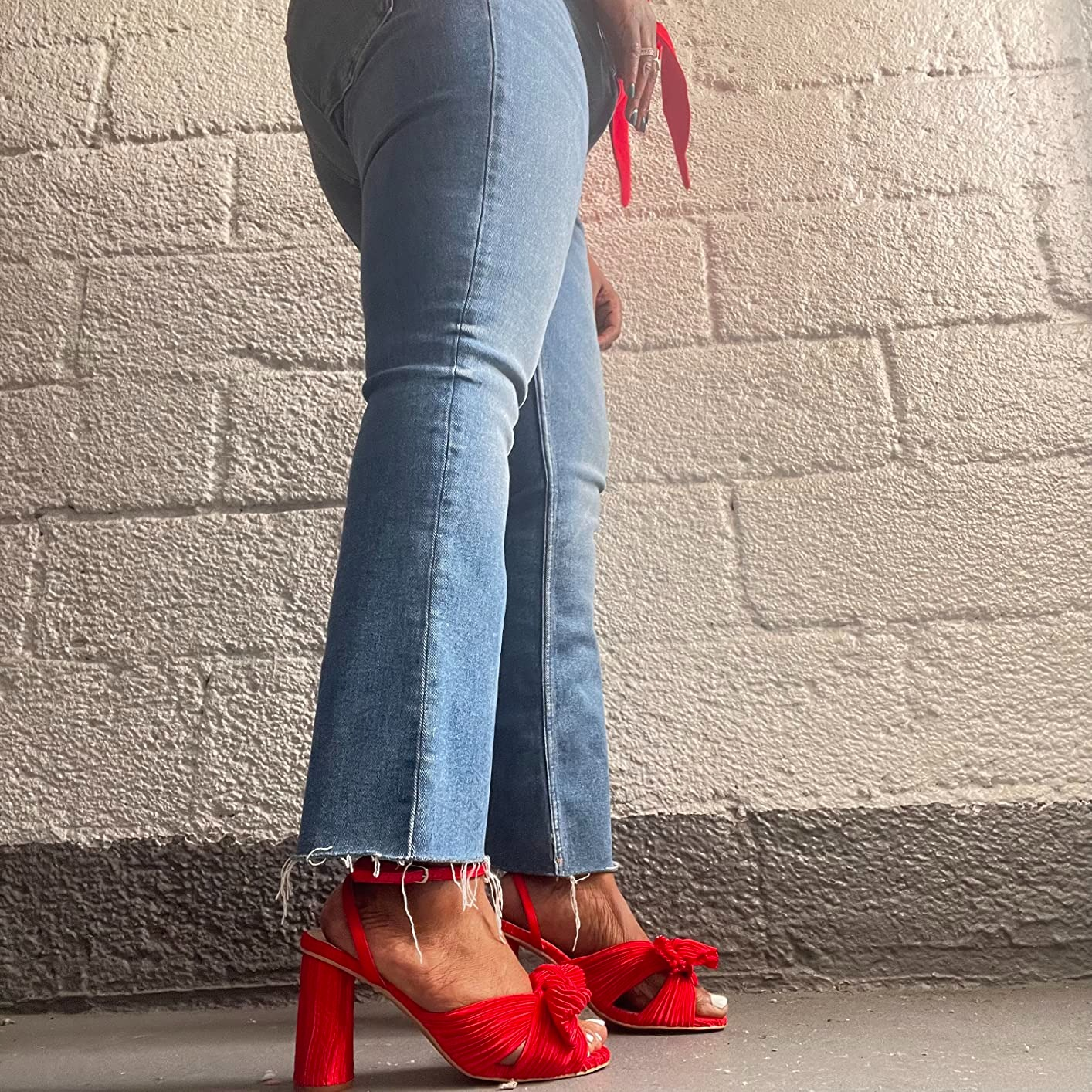 A reviewer showing the broadside  illustration   of the heels successful  red