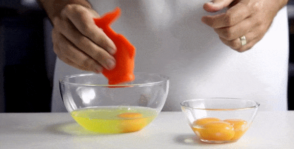 chef using the fish shaped yolk separator to gobble up a yolk