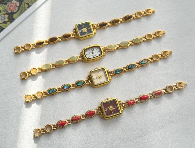 four watches with antithetic earthy stones connected the concatenation and ticker look colors and shapes