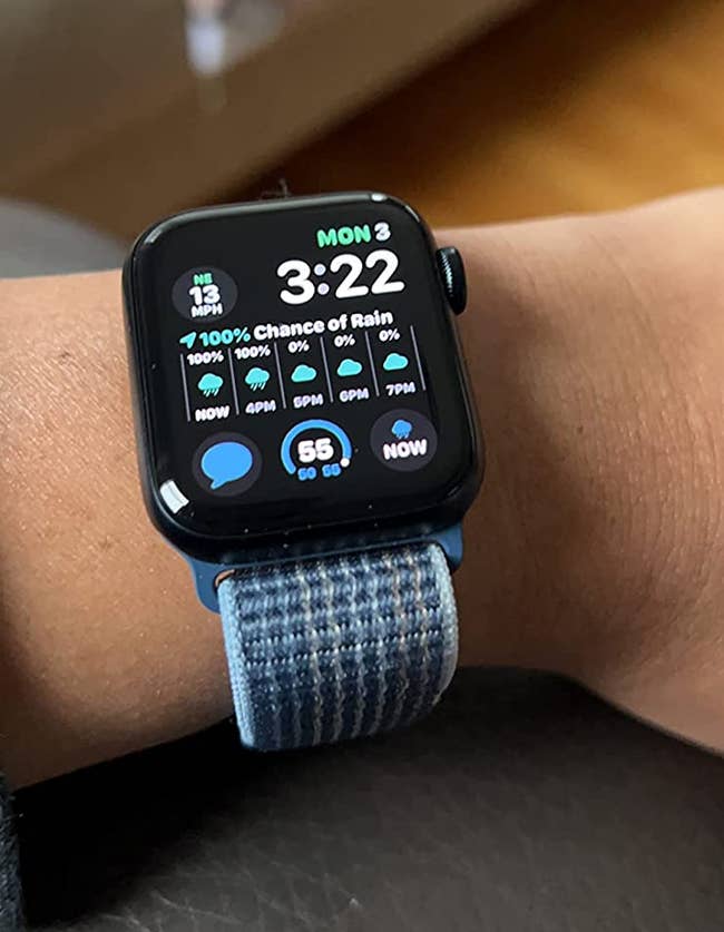 image of the apple watch on a reviewer's wrist; it's showing weather patterns