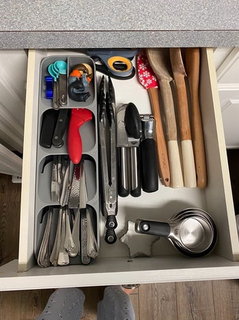 on right, reviewer pic of same drawer all organized with silver silverware sorter on the left side