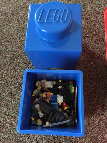 reviewer photo of blue Lego storage bin with Lego minifigures inside