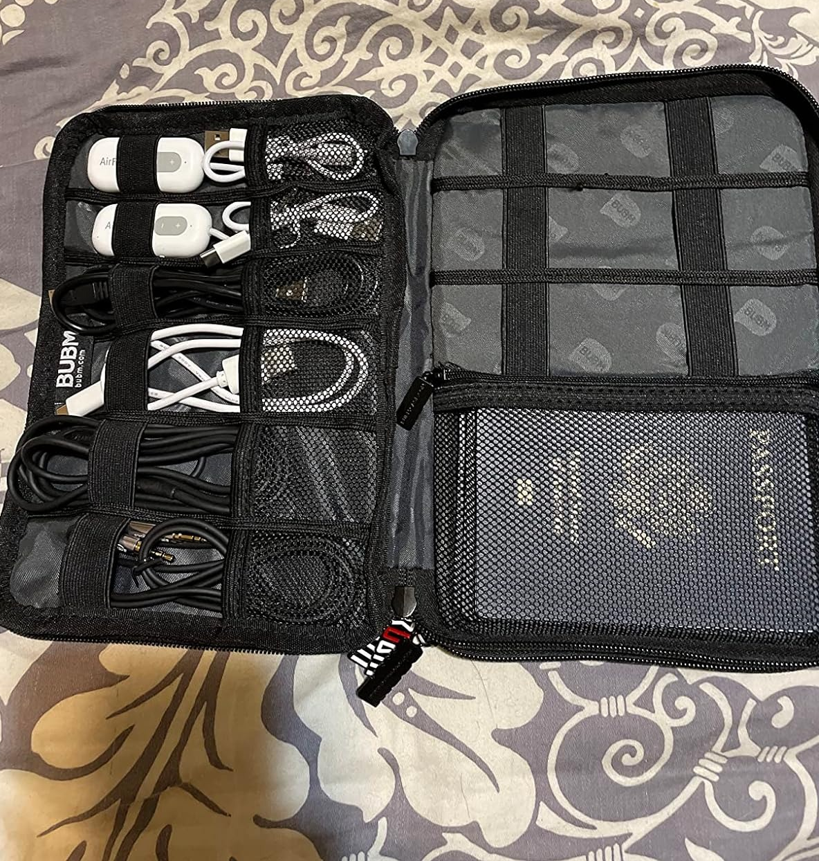 the reviewer pouch with electronic's cords and a passport