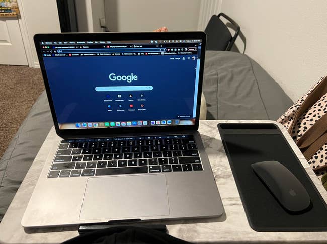 reviewer photo of the laptop  and a mouse on the lap desk