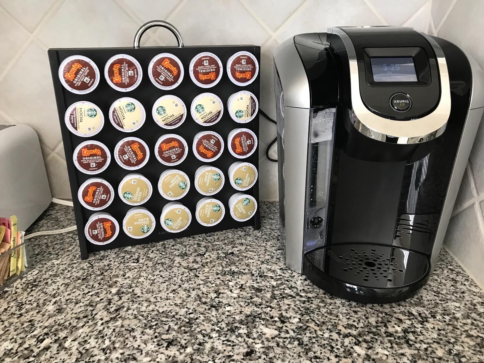 Reviewer photo of the stand with K-cups in them next to a Keurig