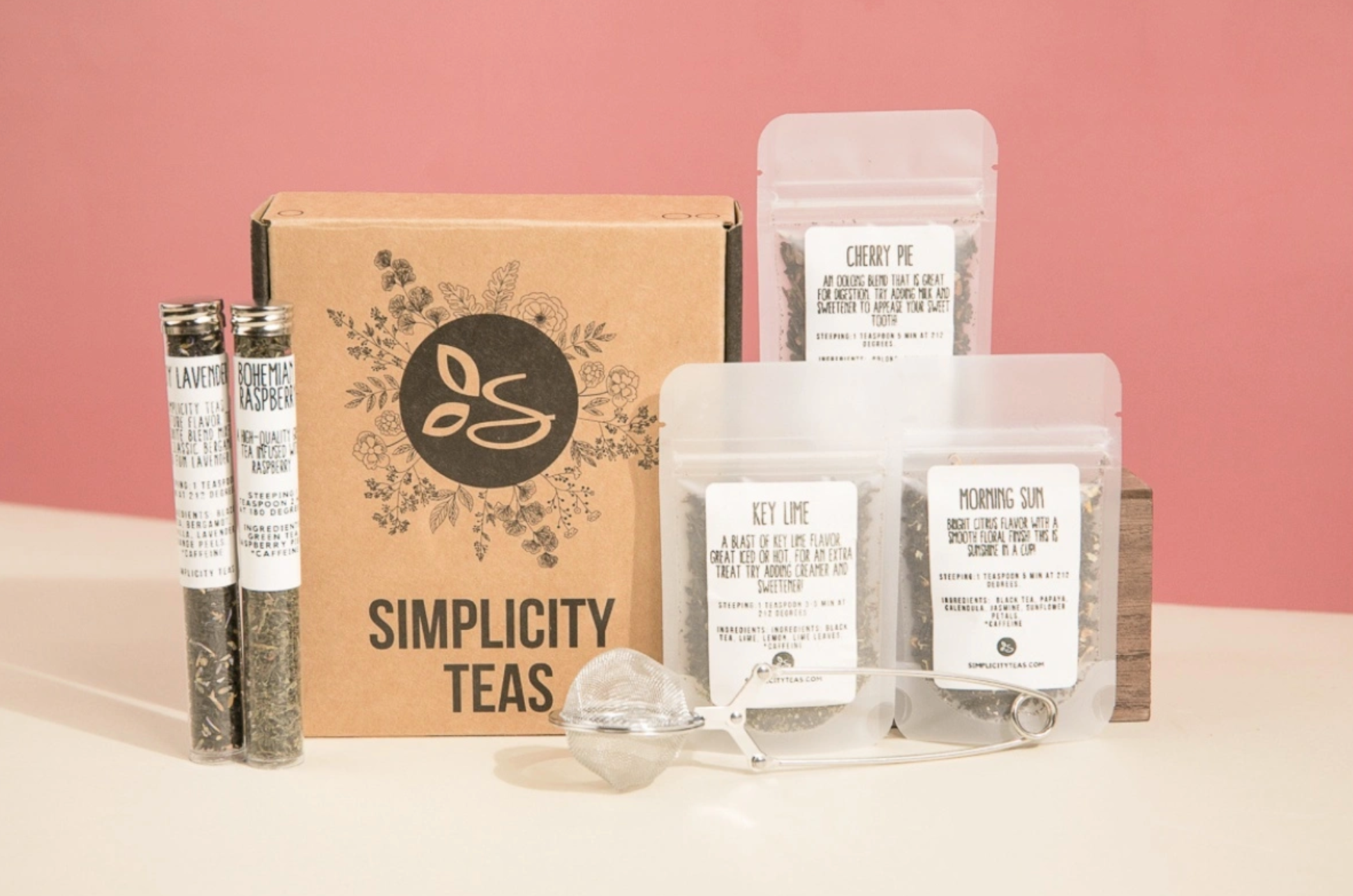 assortment of loose leaf teas and a tea infuser
