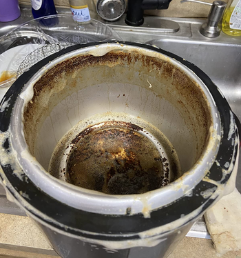 inside of a reviewer's cooking pot looking super dirty