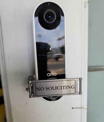 Arlo video doorbell mounted on a wall with a 