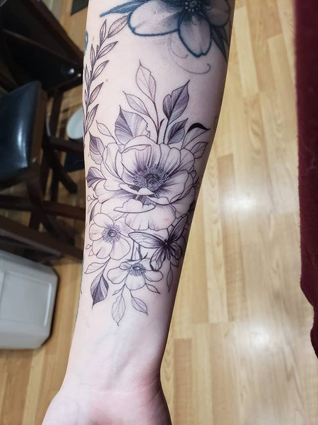 image of temporary floral tattoo on a reviewer's forearm