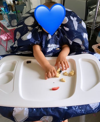 reviewer photo of their child wearing the bib