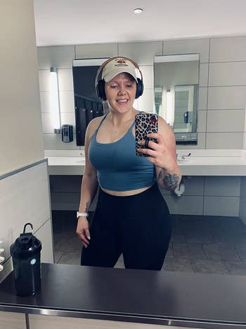 reviewer mirror gym selfie wearing blue tank top