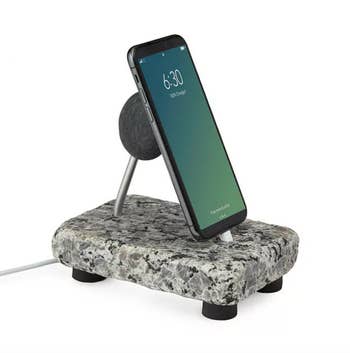 iphone charging on rock phone stand