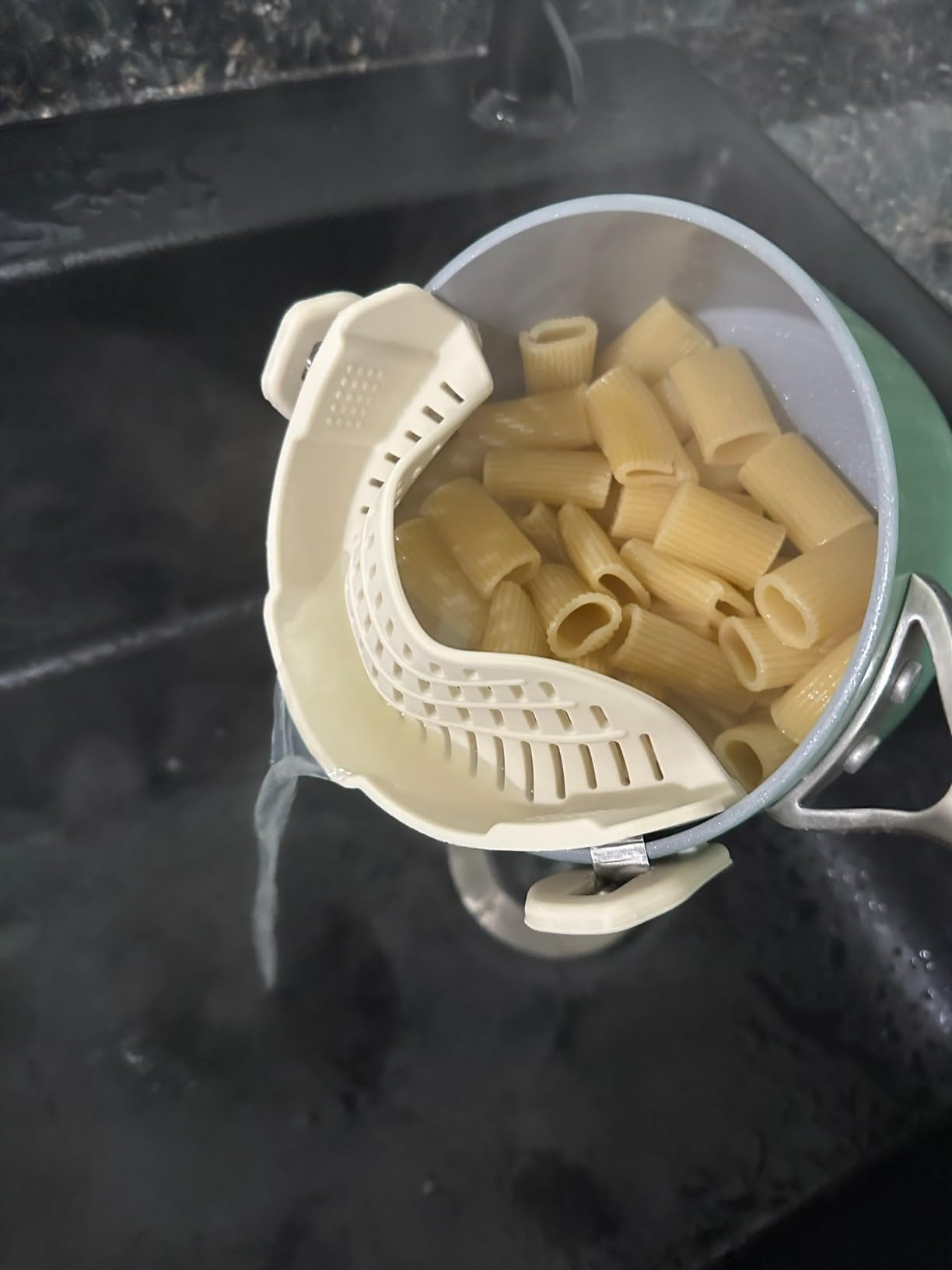 A pot with a clip-on strainer
