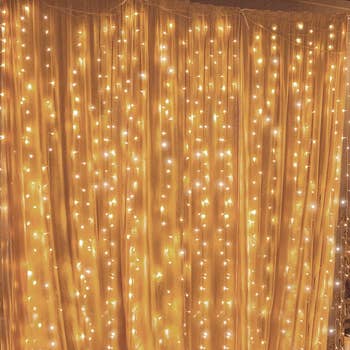 Product over white sheer curtains illuminating warm gold glow