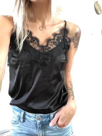 reviewer wearing the black lace cami